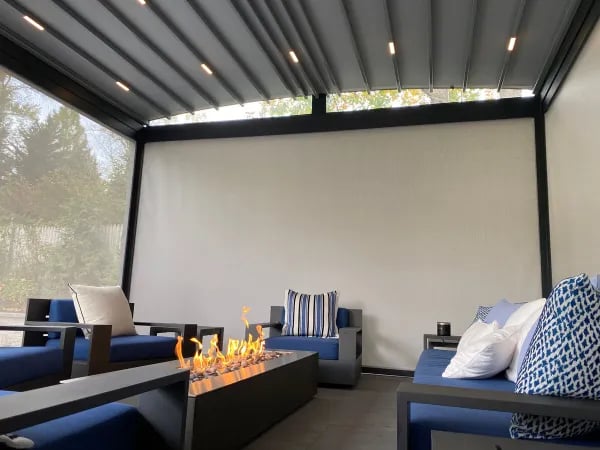Motorized screen shade decorated with blue sofas and fire pit