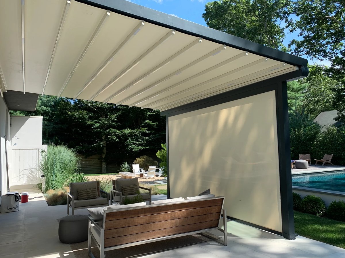 Retractable pergola in backyard seating area