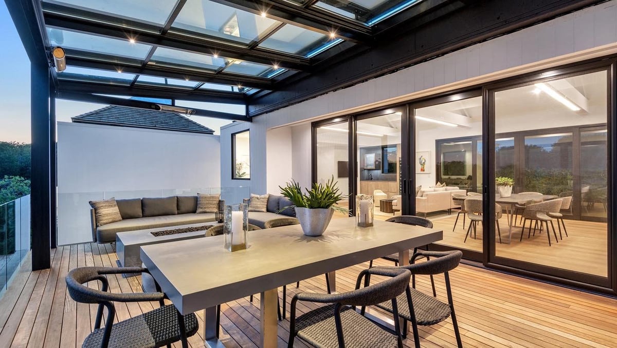 A sunroom with a table and chairs and a couch