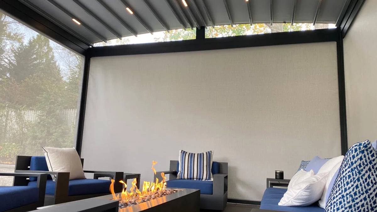 A living room with a couch and a fireplace near a sliding glass door.