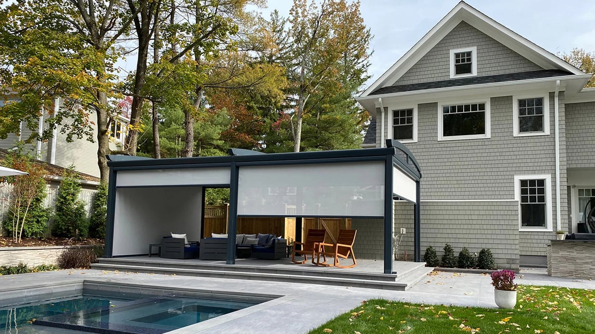 A house with a sliding glass door and a pool in front of it.