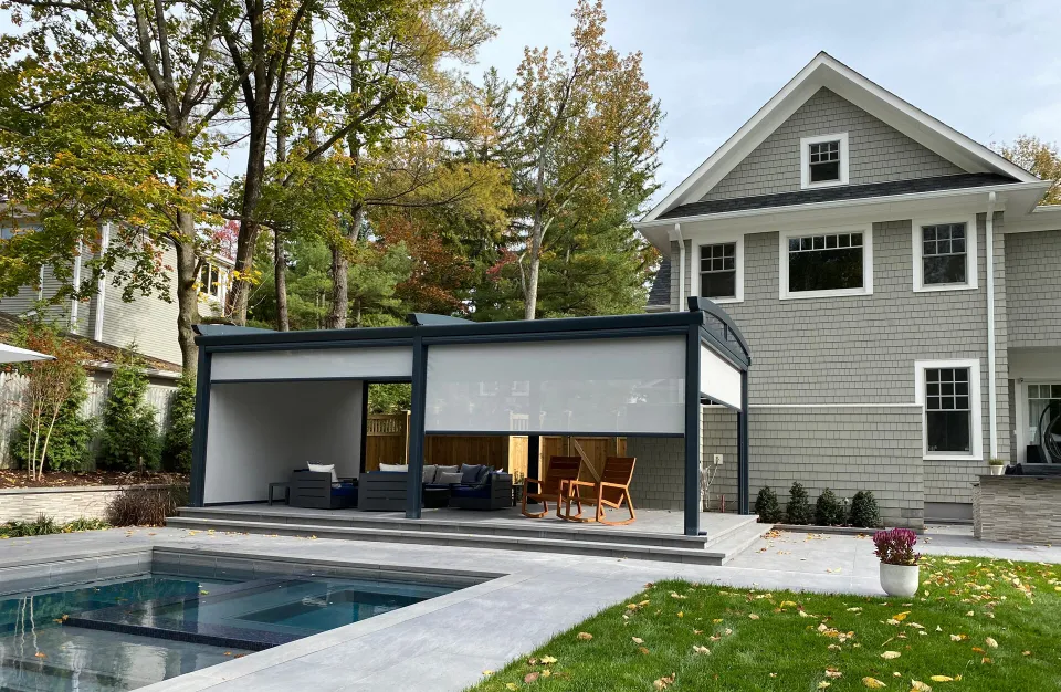 Featured image: A beautiful house with a pool and patio area, complemented by a motorized screen shade - Read full post: Customizing Your Pergola with Motorized Screen Shades: The Possibilities are Endless