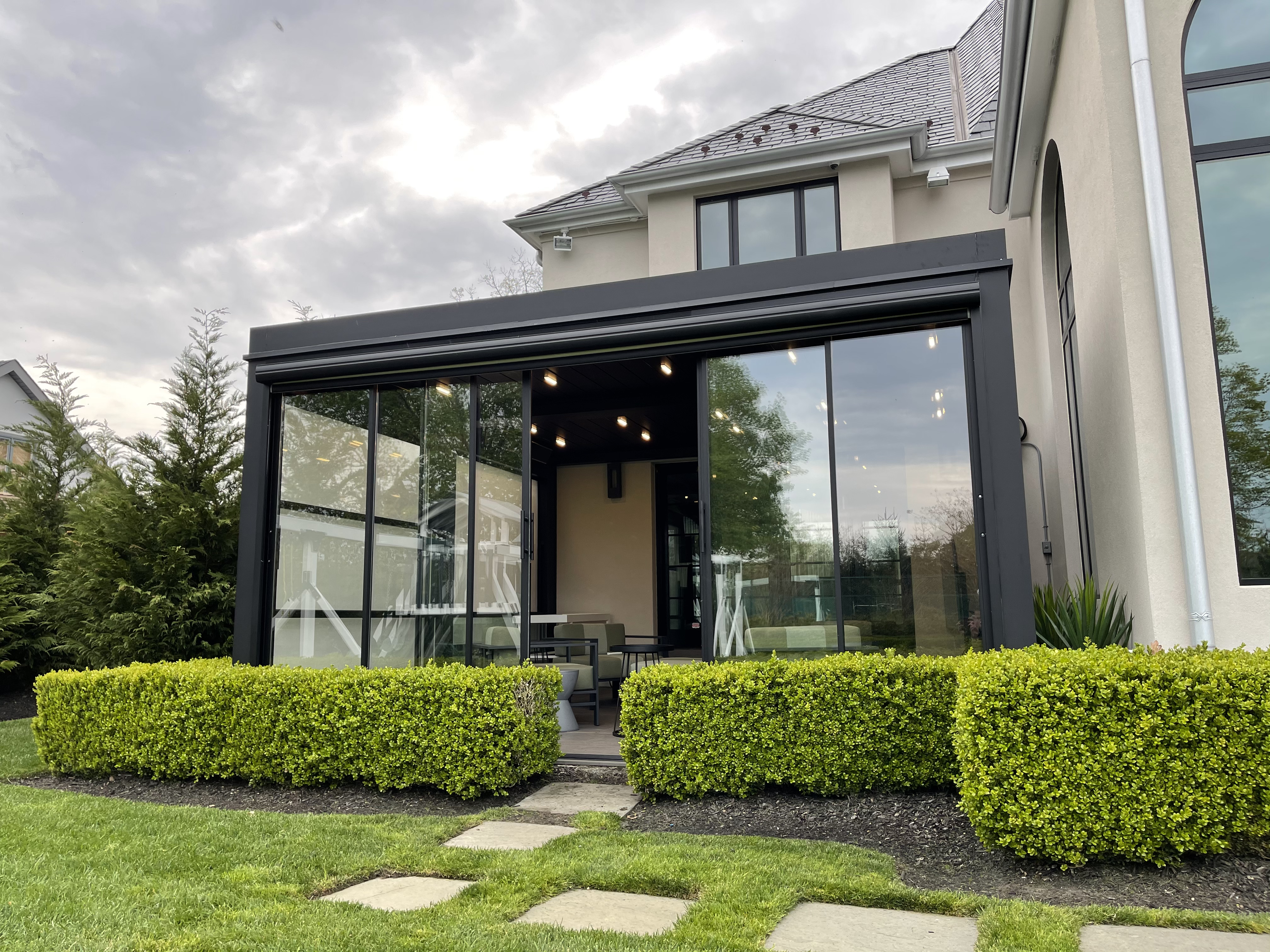 Featured image: A contemporary residence featuring guillotine glass doors and a patio for outdoor relaxation - Read full post: Creating the Ultimate Entertaining Space with Guillotine Glass Barriers