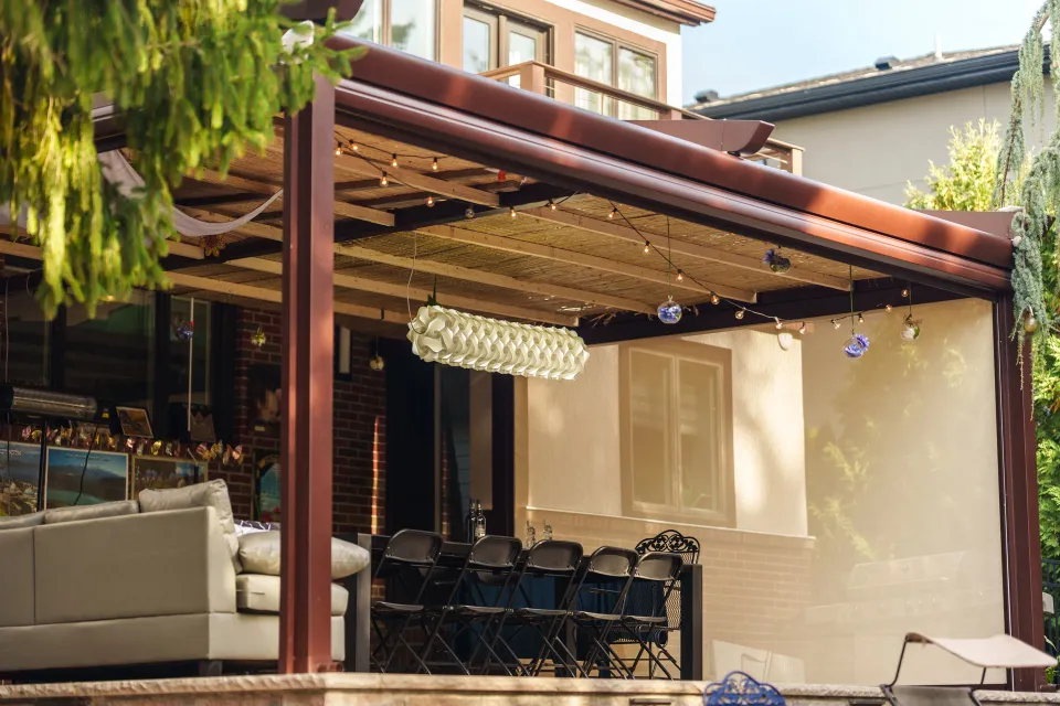 Featured image: A covered patio with a table, chairs, adorned with Sukkah decoration  - Read full post: Unique Sukkah Decorating Ideas for Your Pergola that You Haven't Seen Before